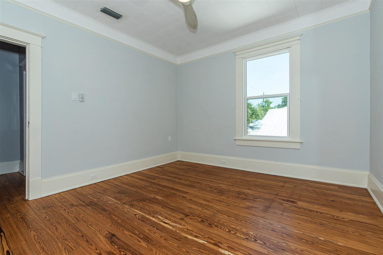 21 Saragossa Street St. Augustine, FL 32084 - Photo 40 of 46 an empty room with wooden floor and windows