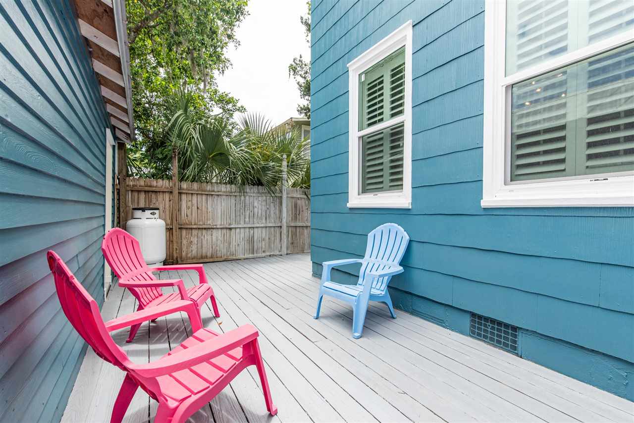 21 Saragossa Street St. Augustine, FL 32084 - Photo 43 of 46 a backyard of a house with wooden floor chairs sofa and barbecue oven