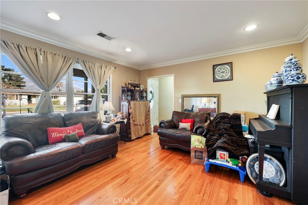 415 Cortez Road Arcadia, CA 91007 - Photo 5 of 27 a living room with furniture a fireplace and a flat screen tv