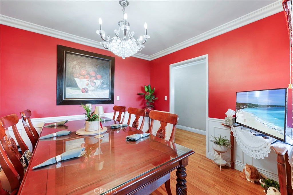 415 Cortez Road Arcadia, CA 91007 - Photo 8 of 27 a view of a dining room with furniture a chandelier and wooden floor