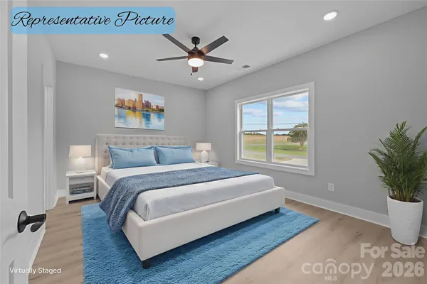 a bedroom with a large bed and a potted plant