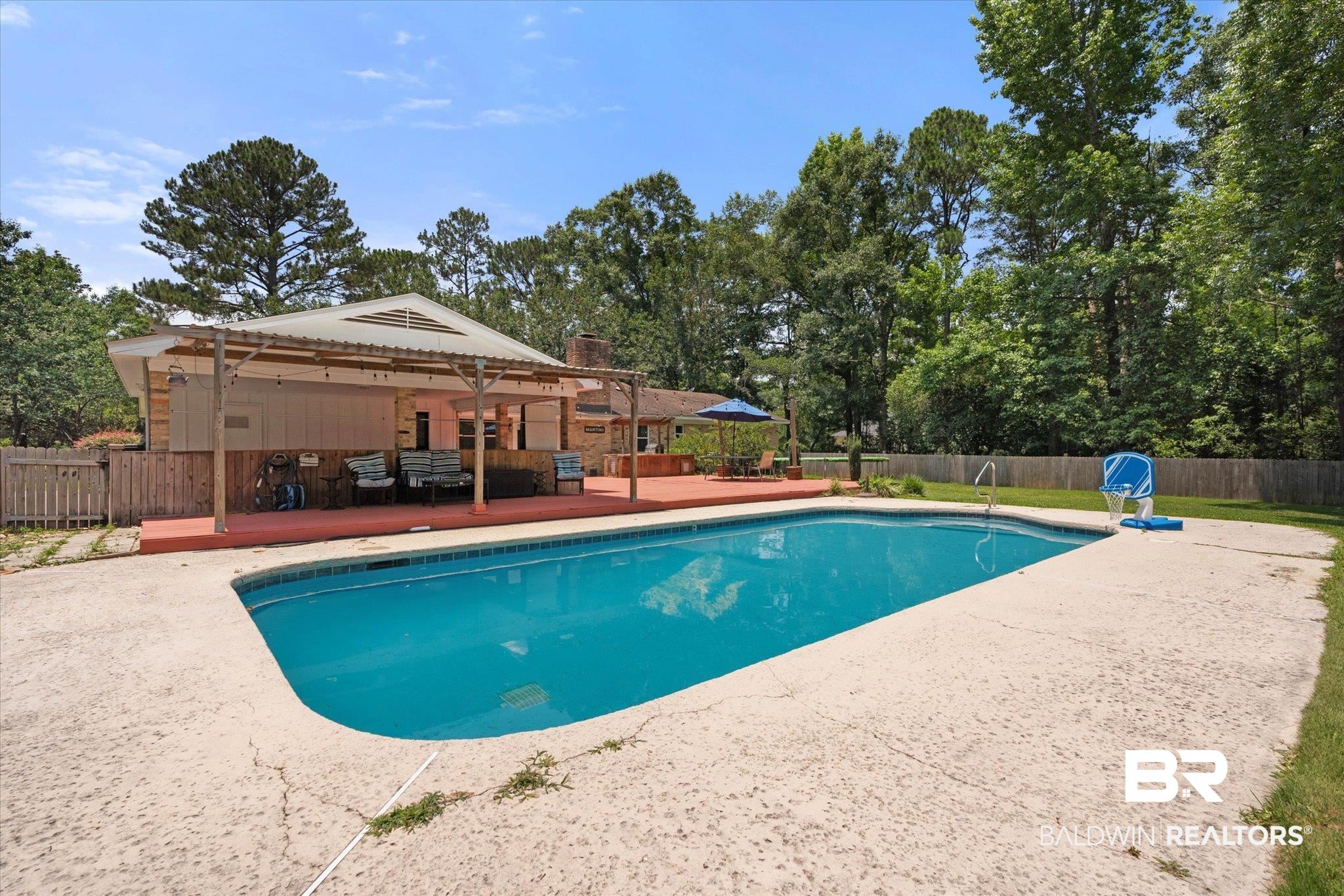 1025 Walter Smith Road Mobile, AL 36695 - Photo 35 of 46 View of pool featuring a deck, a fenced backyard, a patio area, and view of wooded area