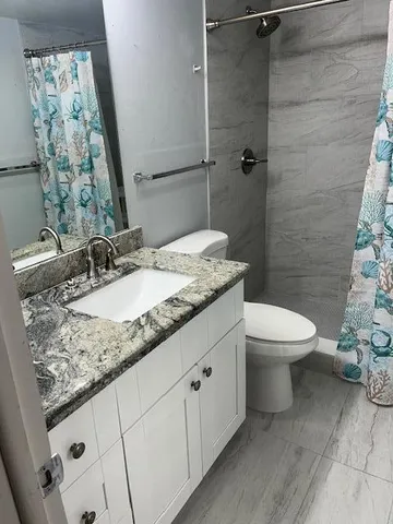 a bed sitting in a bedroom next to a lamp