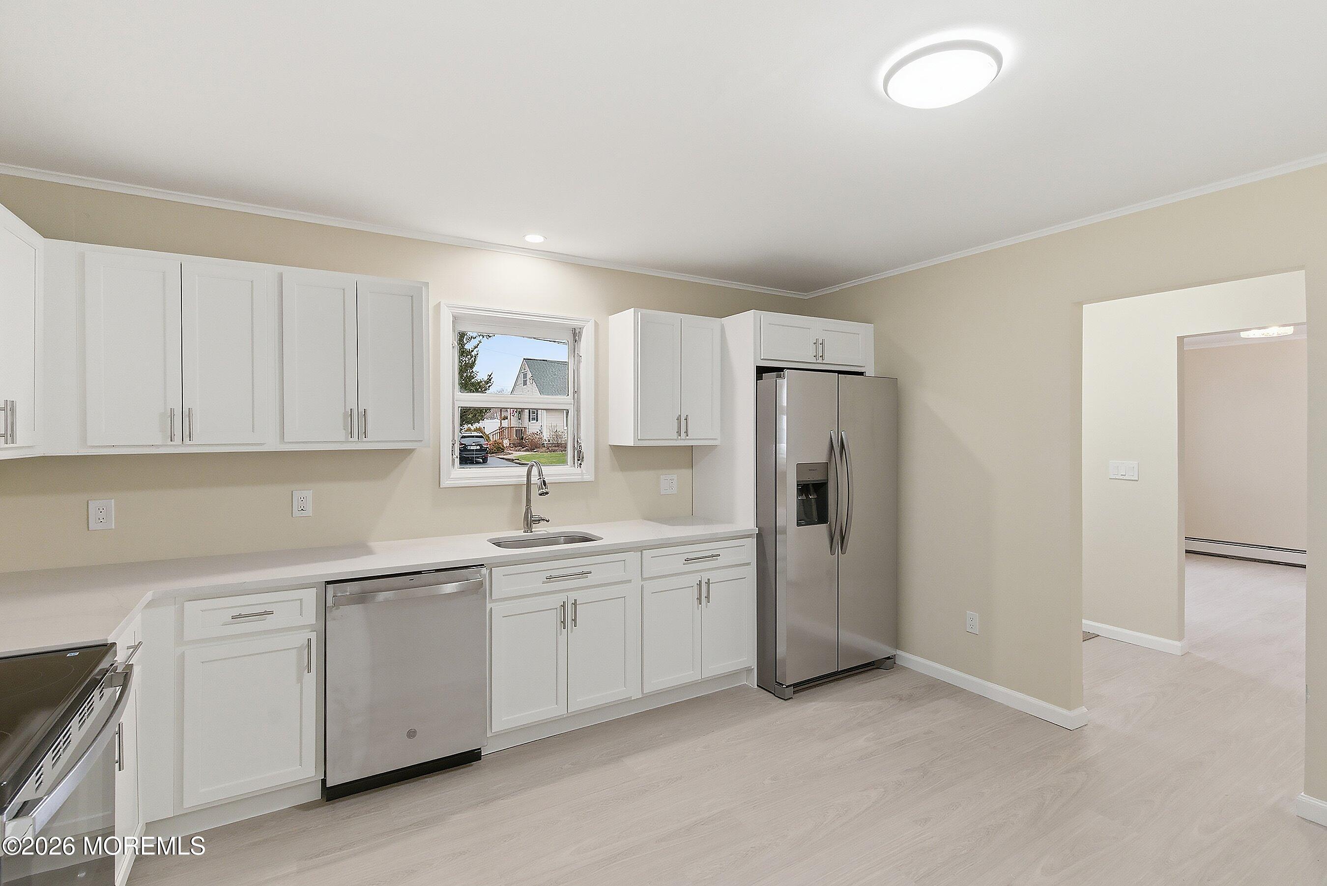 2710 Johnson Street Wall, NJ 07719 - Photo 11 of 38 a kitchen with a sink and refrigerator