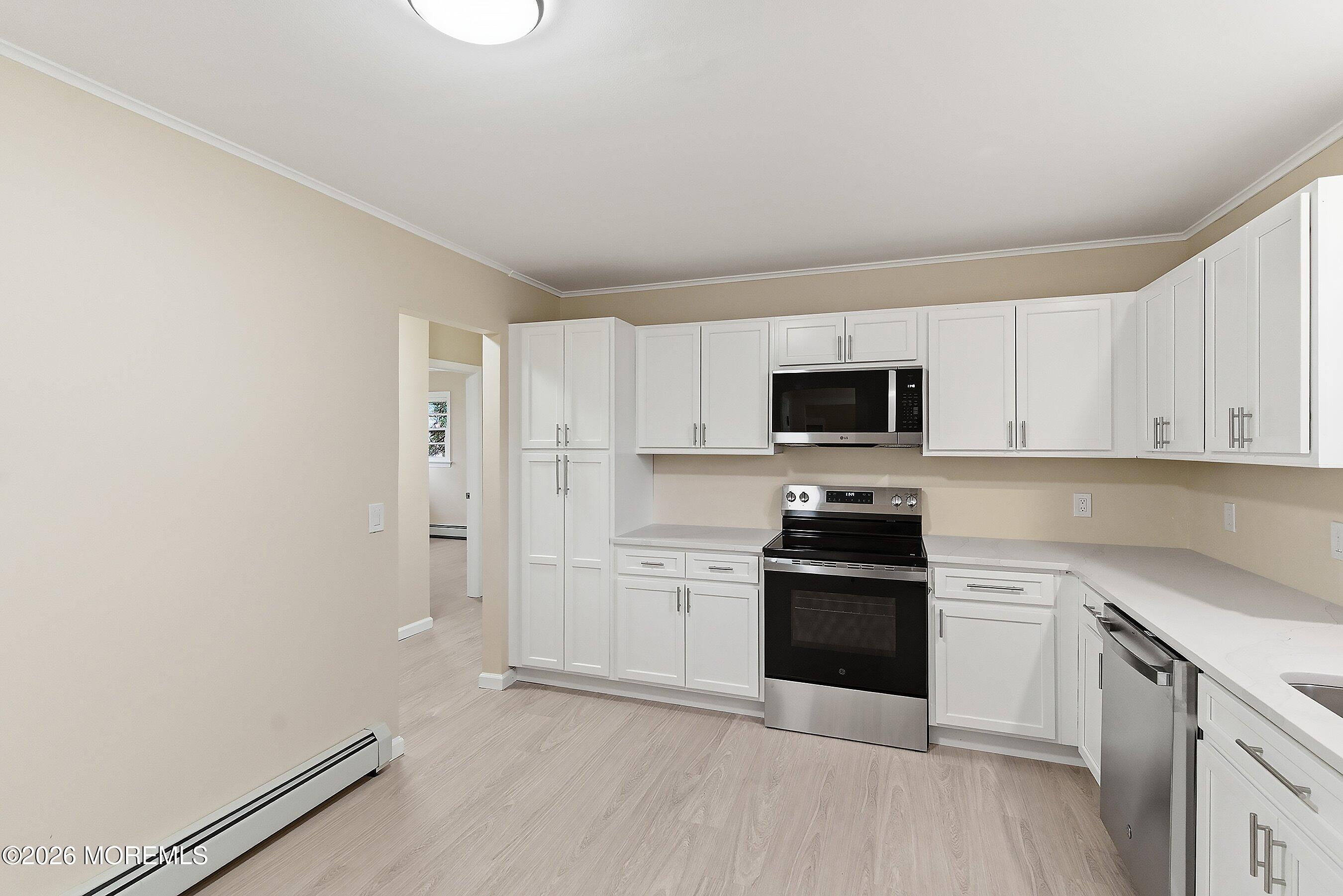 2710 Johnson Street Wall, NJ 07719 - Photo 13 of 38 a kitchen with a stove and a microwave