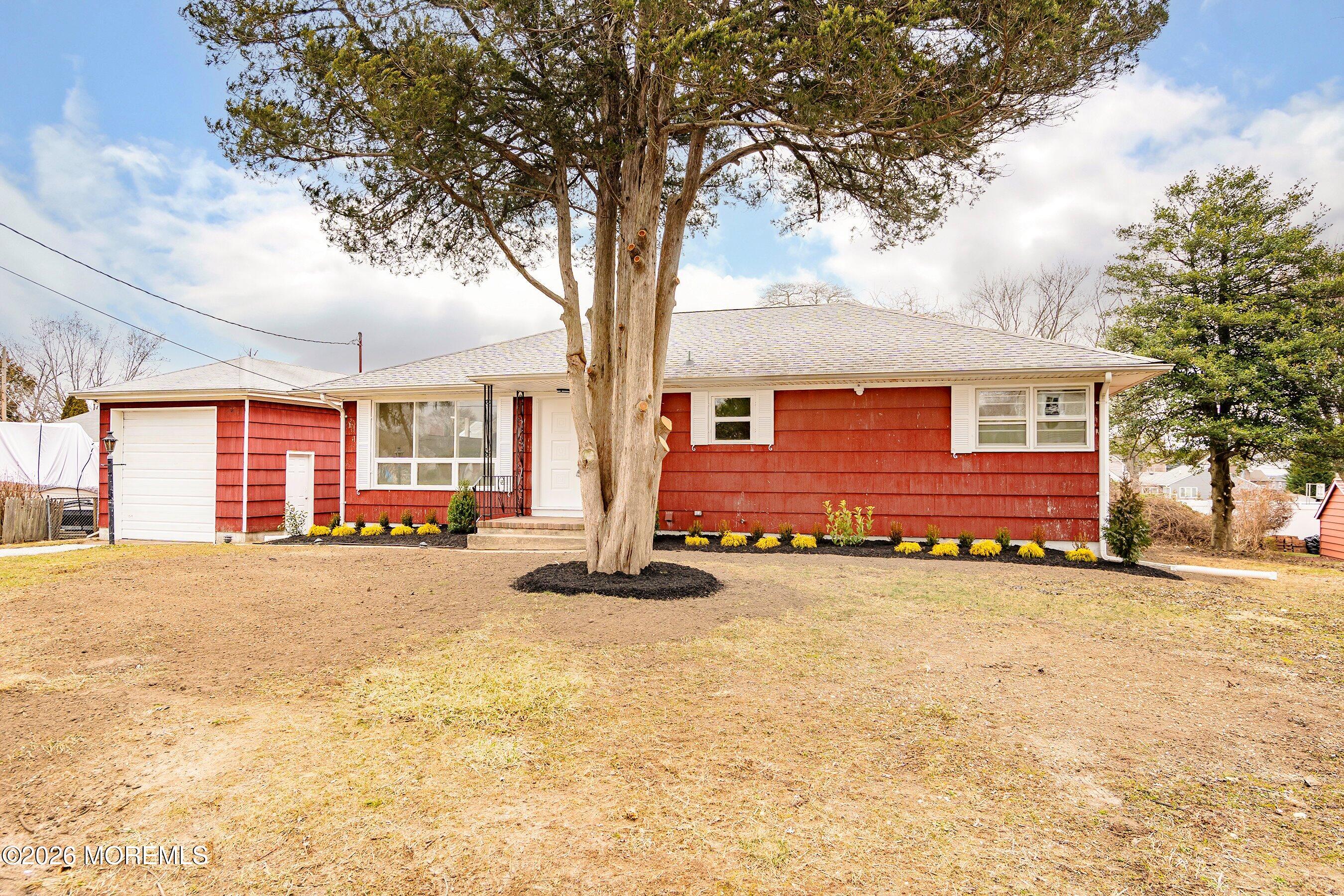 2710 Johnson Street Wall, NJ 07719 - Photo 3 of 38 front view of a house with a large trees