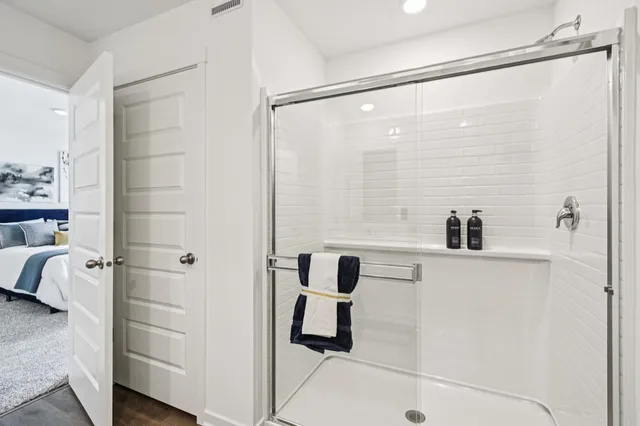 a bathroom with a shower and a sink