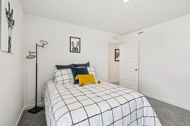 a bedroom with a bed and lamp