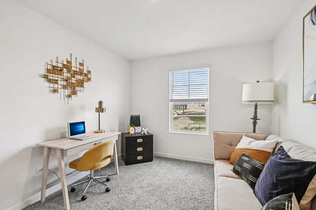 a living room with furniture a window and a chandelier
