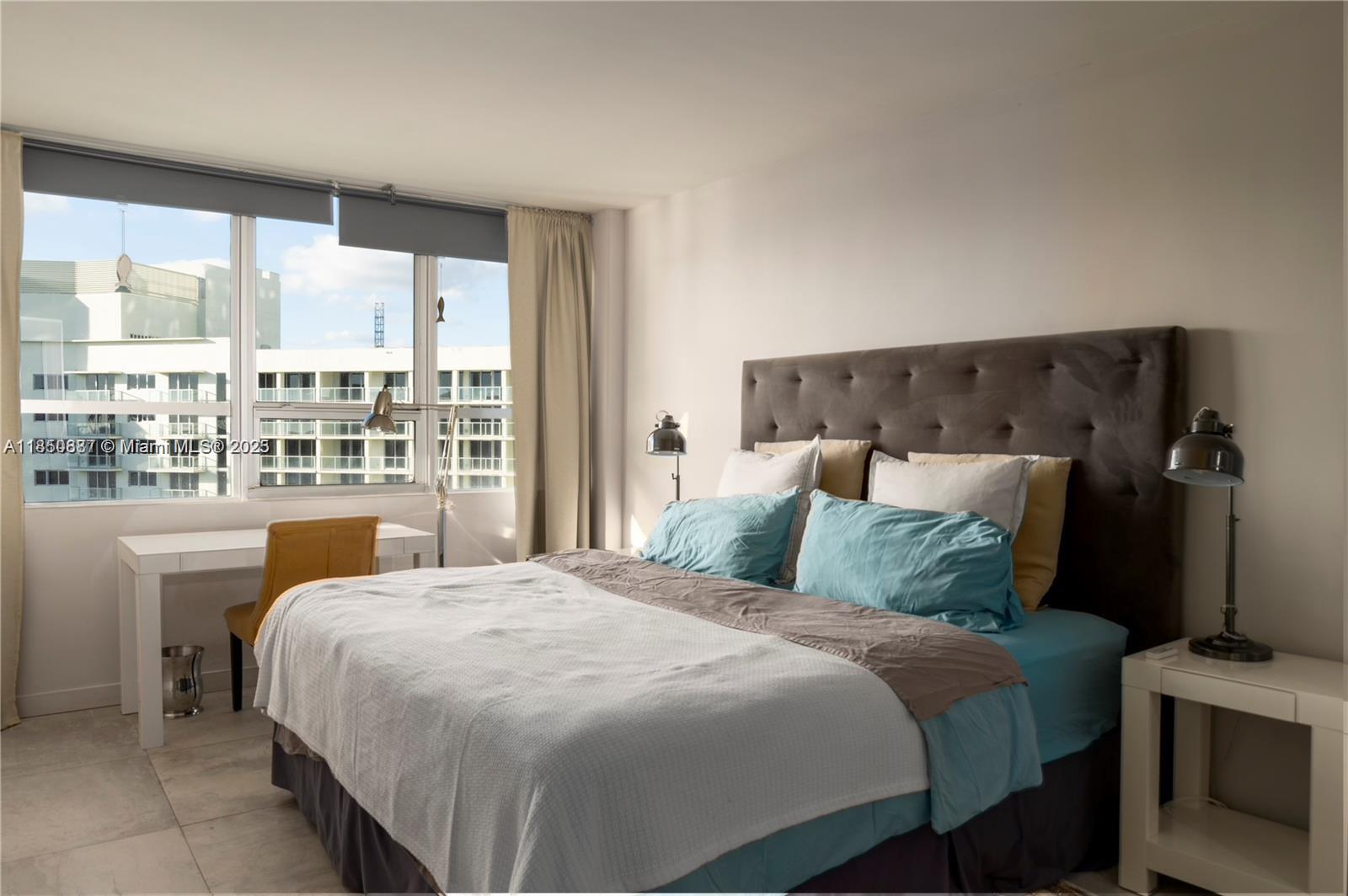 1500 Bay Road, Unit 1464S Miami Beach, FL 33139 - Photo 6 of 13 a bedroom with a large bed and a large window