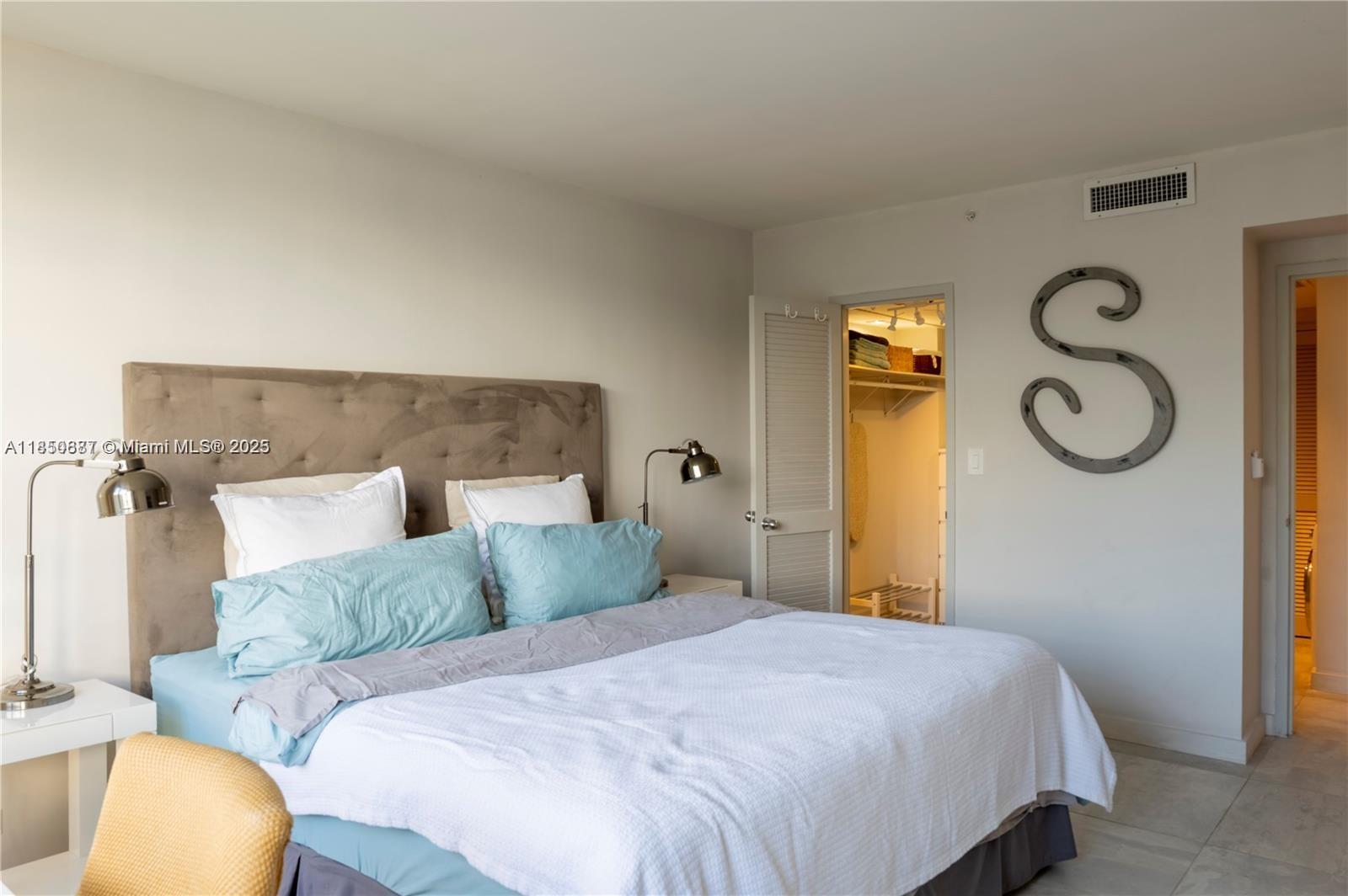 1500 Bay Road, Unit 1464S Miami Beach, FL 33139 - Photo 8 of 13 a bedroom with a bed and fan