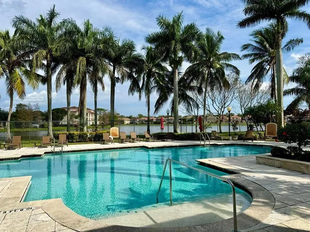 a view of a swimming pool with a table and chairs