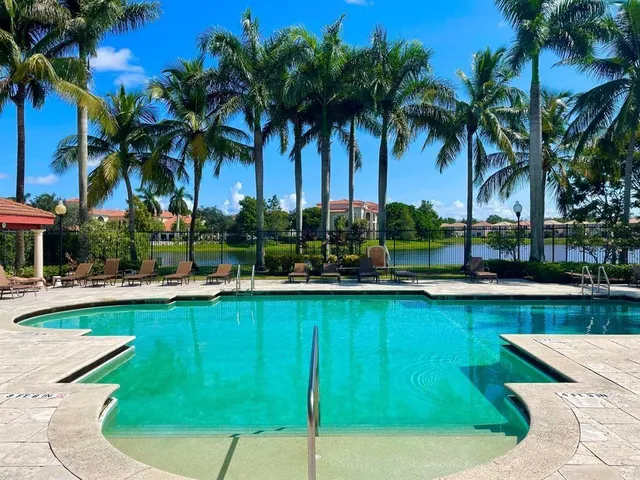 a view of a swimming pool with a table and chairs