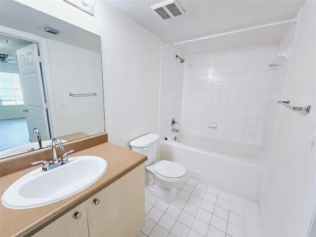 a bathroom with a sink toilet tub and shower