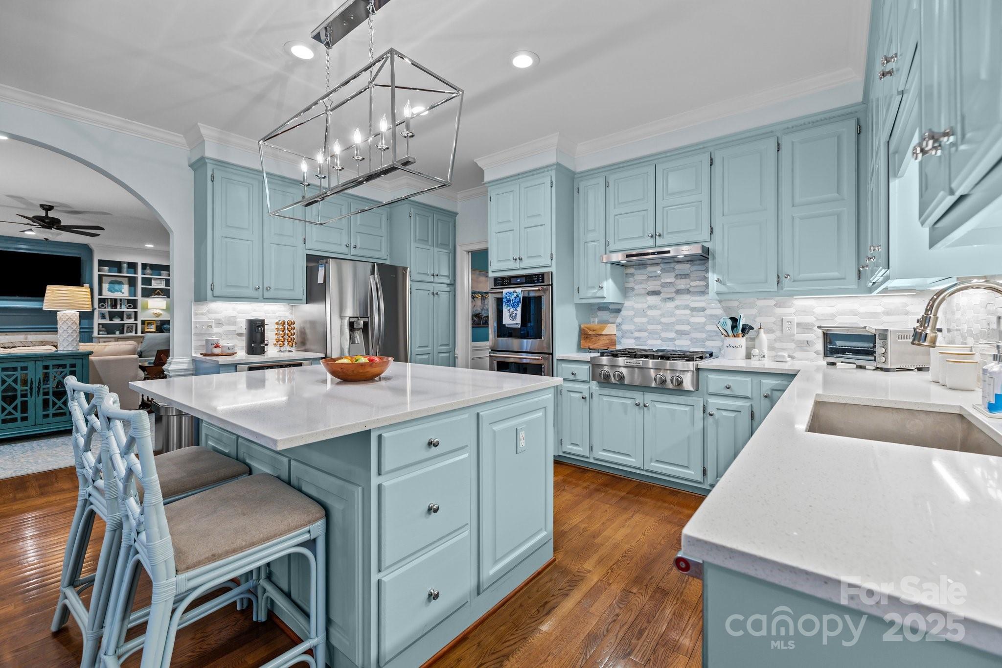 4739 Binfords Ridge Road Charlotte, NC 28226 - Photo 13 of 47 a kitchen with kitchen island granite countertop a sink cabinets and wooden floor