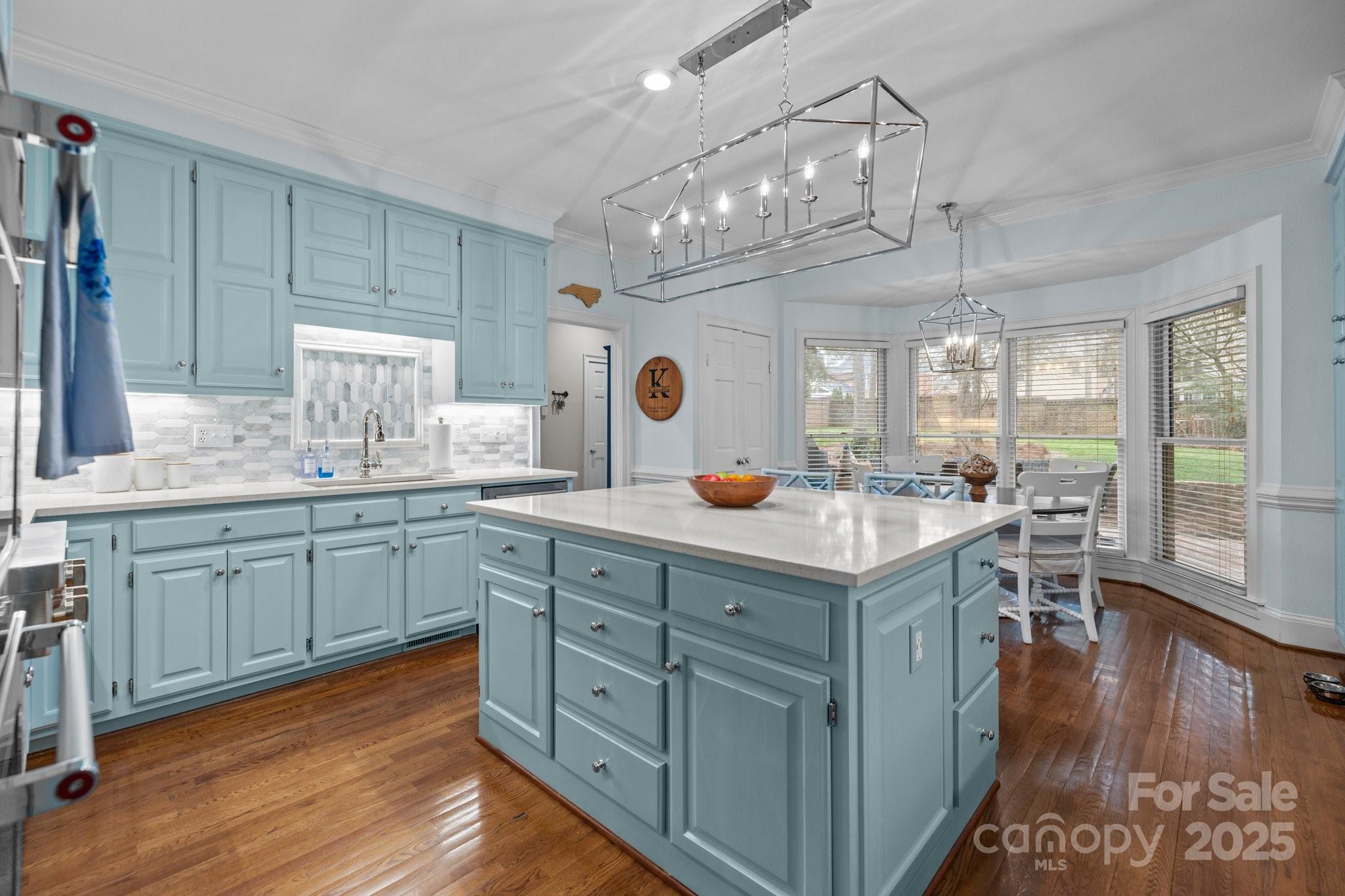 4739 Binfords Ridge Road Charlotte, NC 28226 - Photo 14 of 47 a kitchen with kitchen island granite countertop a sink cabinets and wooden floor