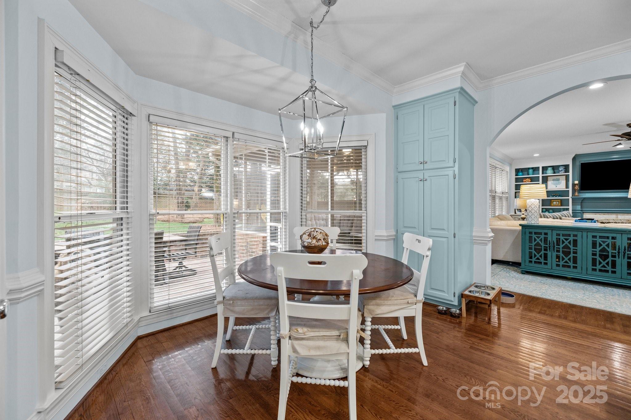 4739 Binfords Ridge Road Charlotte, NC 28226 - Photo 16 of 47 a dining room with furniture wooden floor and a chandelier