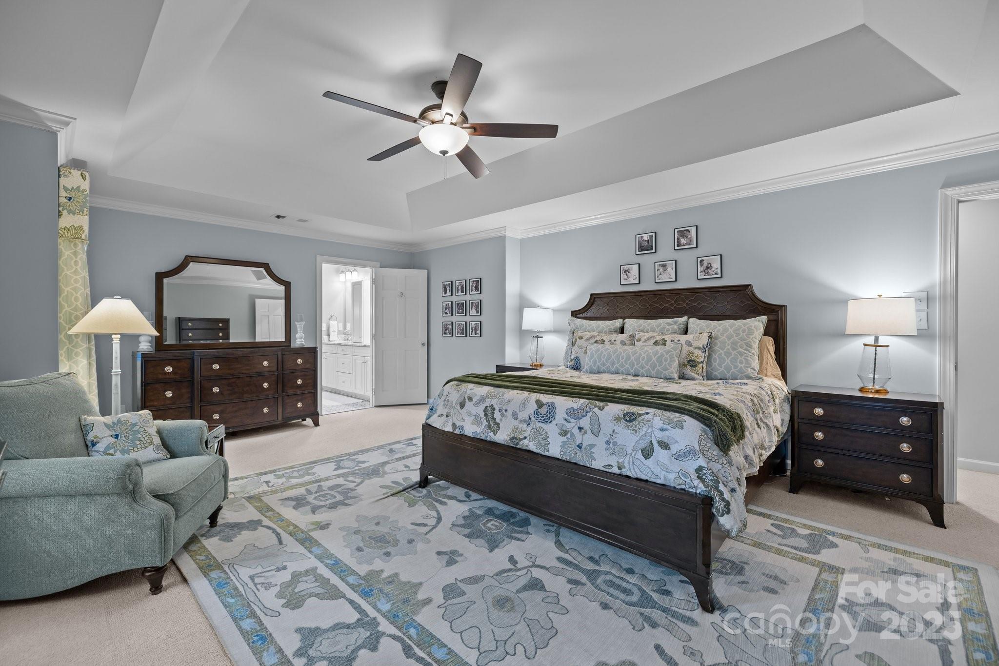 4739 Binfords Ridge Road Charlotte, NC 28226 - Photo 21 of 47 a bedroom with a bed and a chandelier