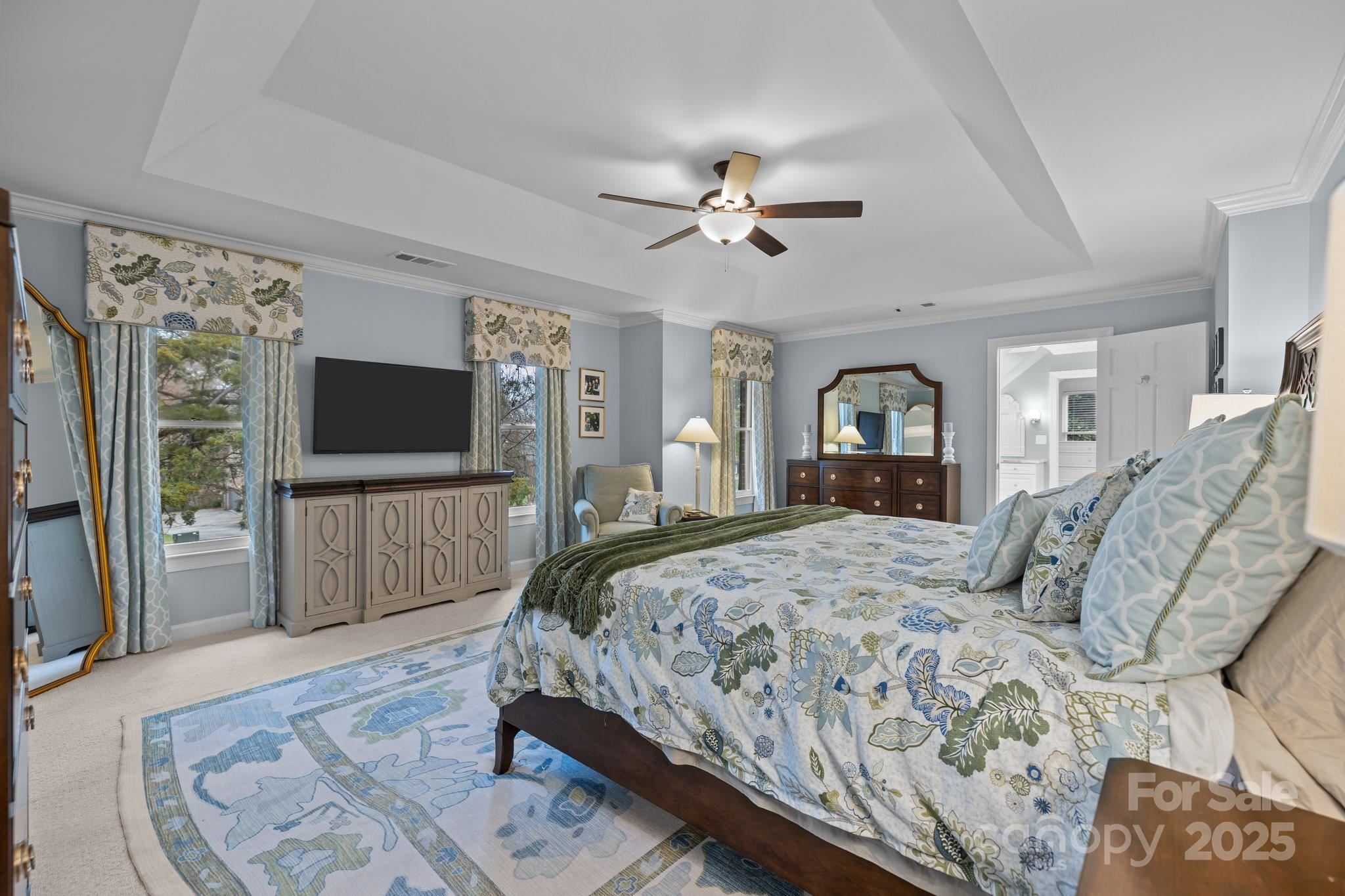 4739 Binfords Ridge Road Charlotte, NC 28226 - Photo 22 of 47 a bedroom with a bed and a flat tv screen on dresser
