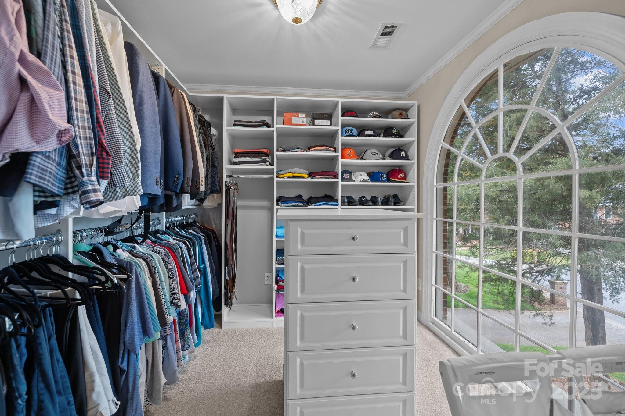 4739 Binfords Ridge Road Charlotte, NC 28226 - Photo 23 of 47 a view of walk in closet with clothes and shoes