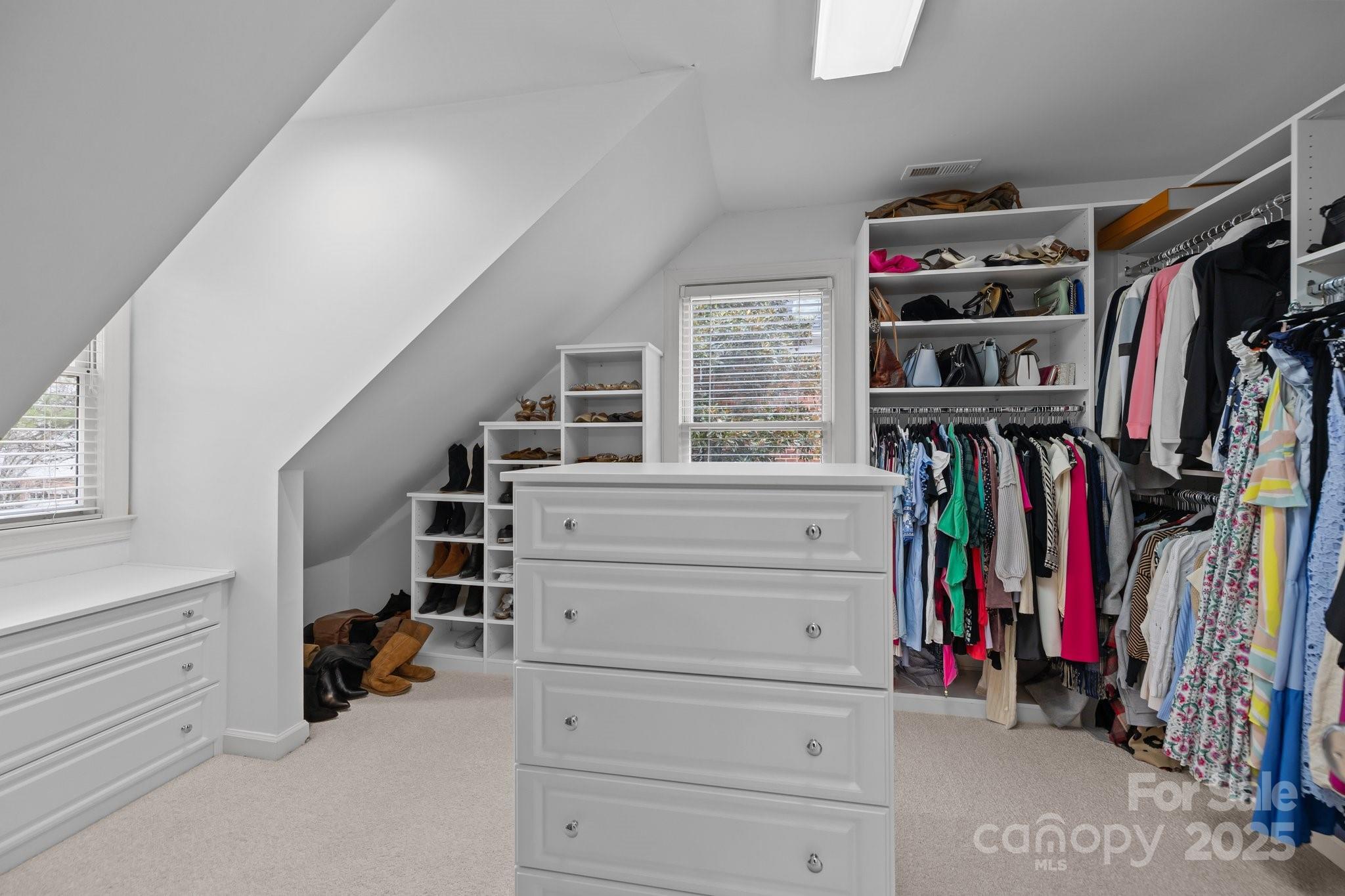 4739 Binfords Ridge Road Charlotte, NC 28226 - Photo 26 of 47 a view of walk in closet with clothes and shoes