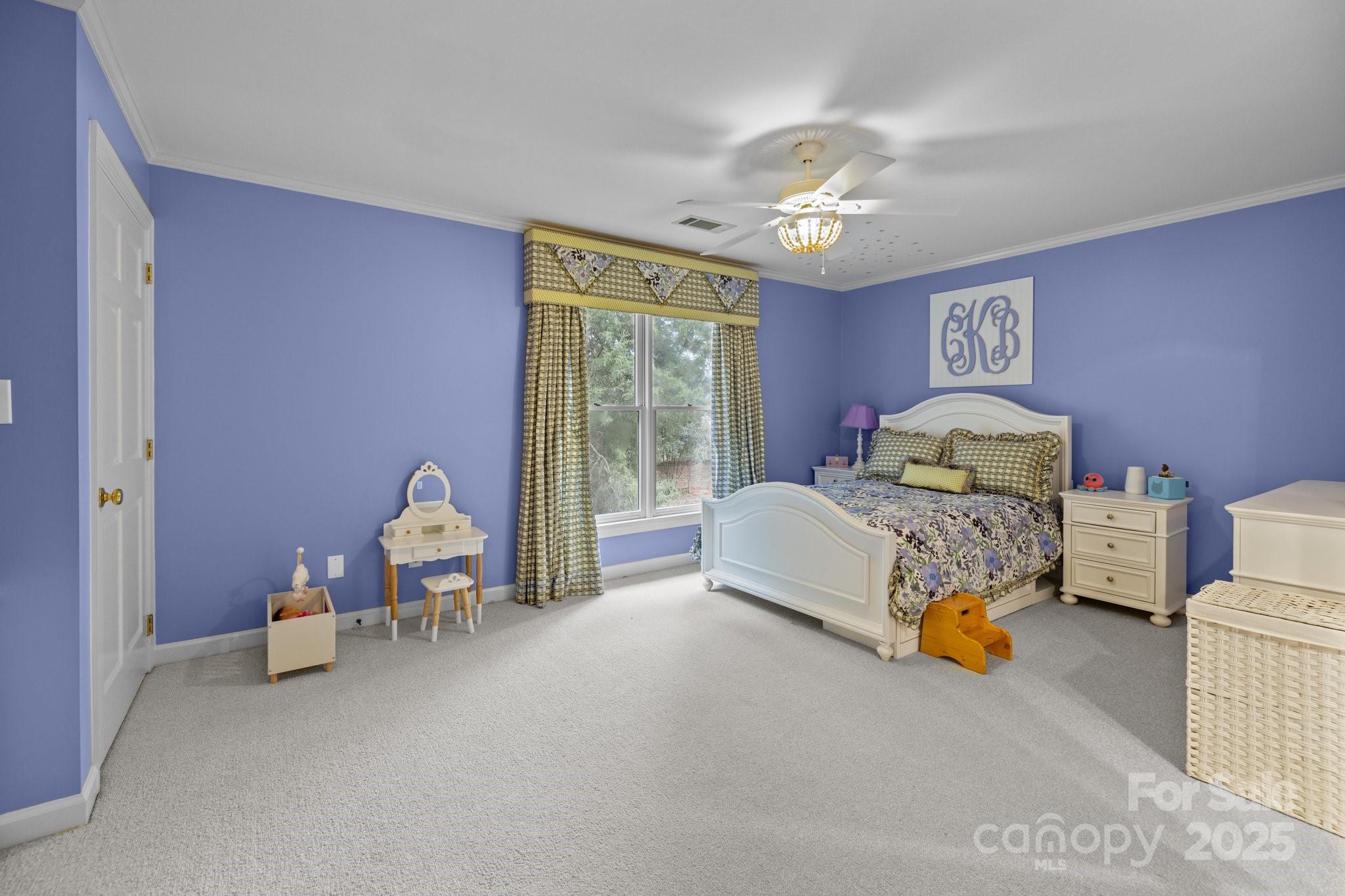 4739 Binfords Ridge Road Charlotte, NC 28226 - Photo 27 of 47 a bedroom with a bed and a chandelier