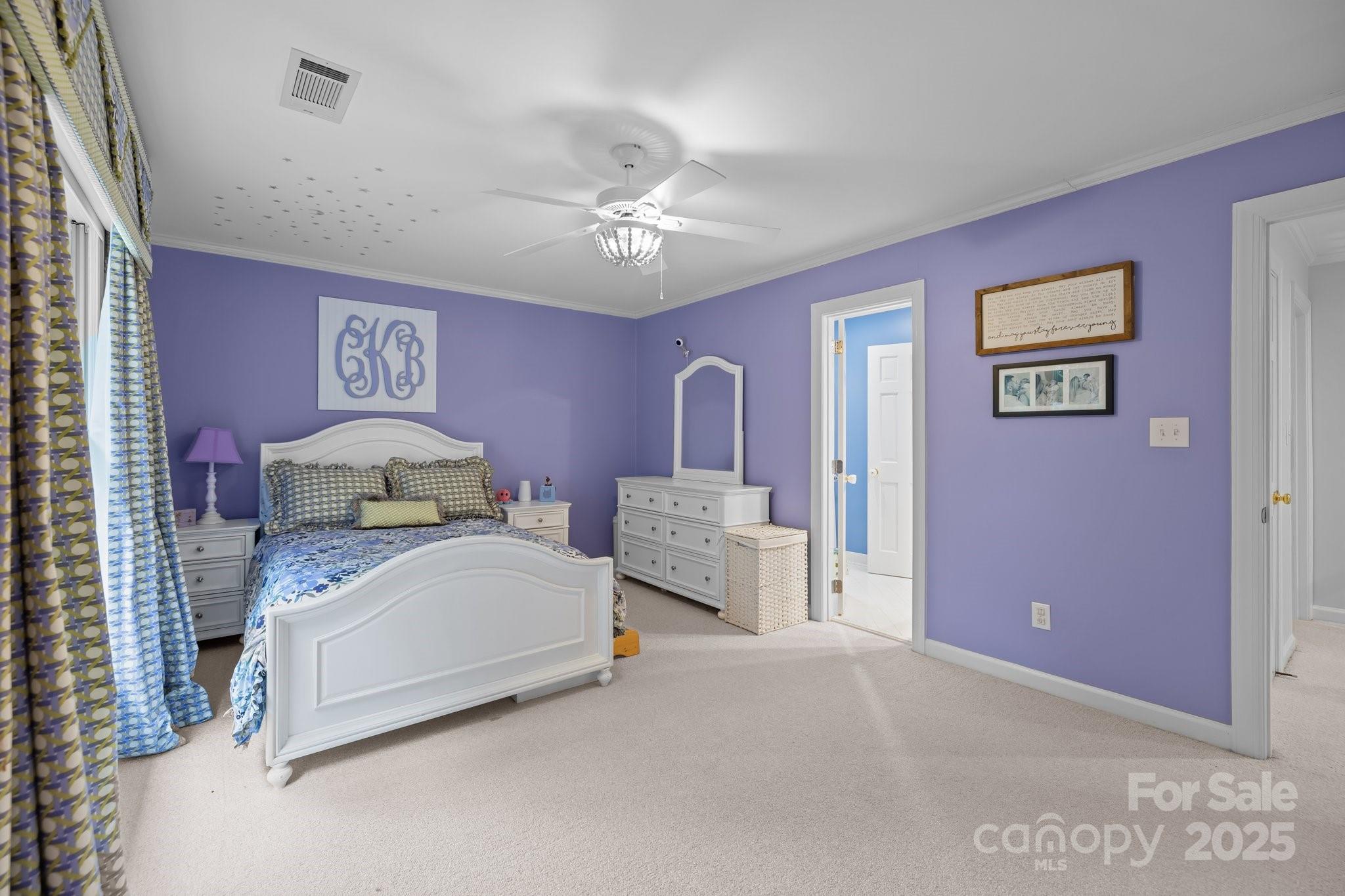 4739 Binfords Ridge Road Charlotte, NC 28226 - Photo 28 of 47 a spacious bedroom with a bed and a chandelier