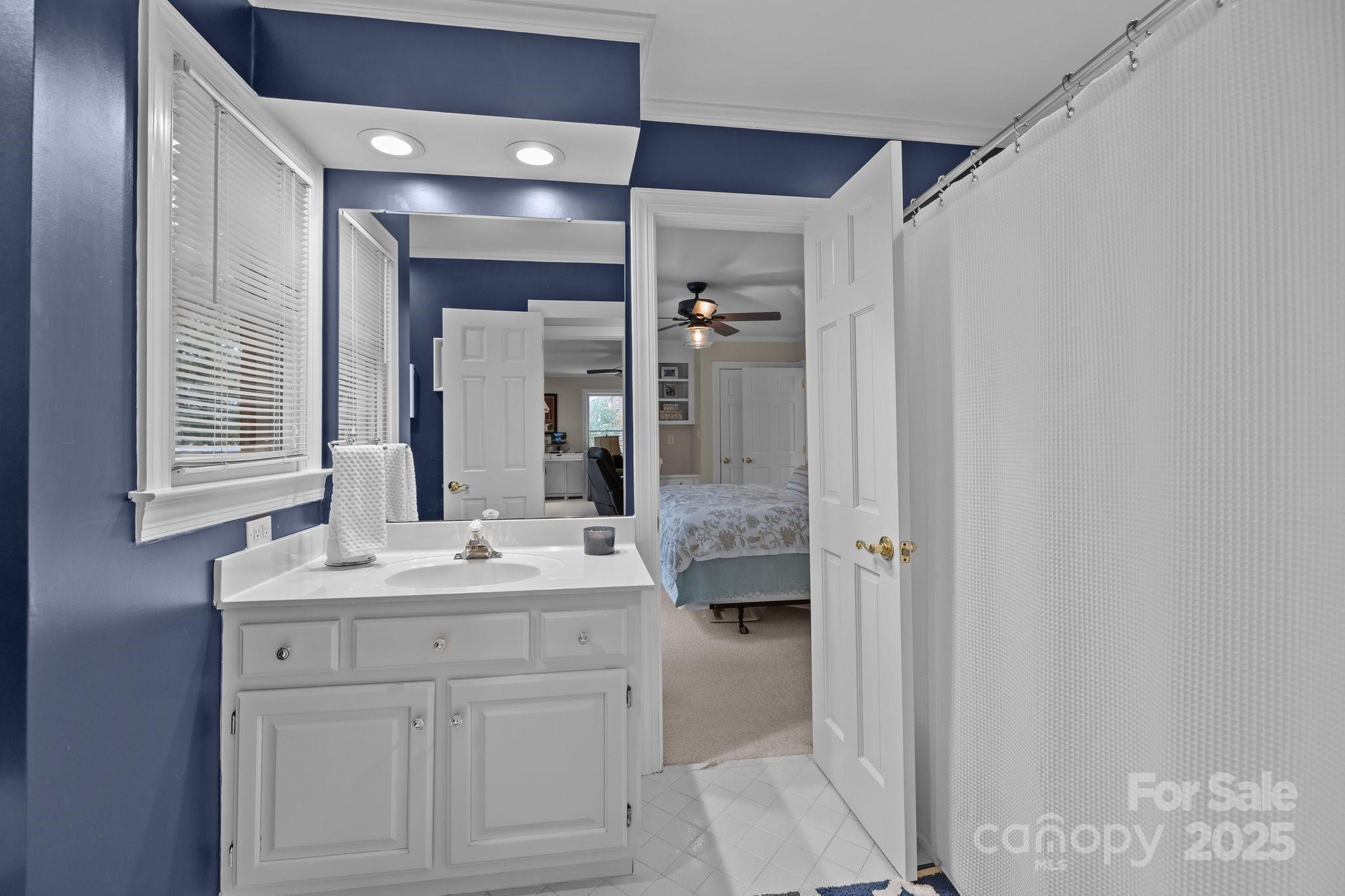 4739 Binfords Ridge Road Charlotte, NC 28226 - Photo 33 of 47 a bathroom with a sink a mirror and a shower