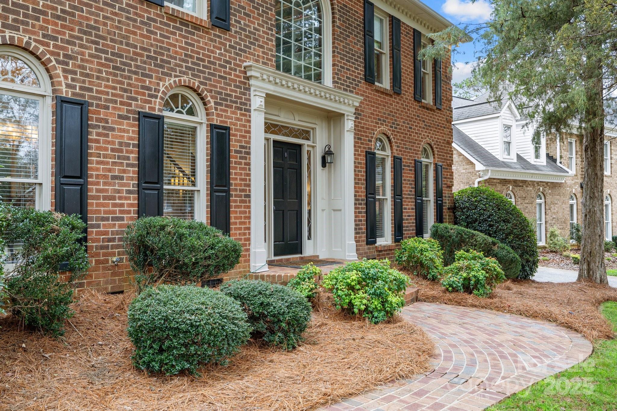 4739 Binfords Ridge Road Charlotte, NC 28226 - Photo 4 of 47 two potted plants in front of a brick building