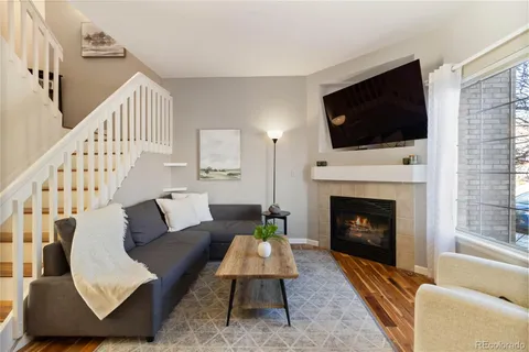 a living room with furniture fireplace and flat screen tv