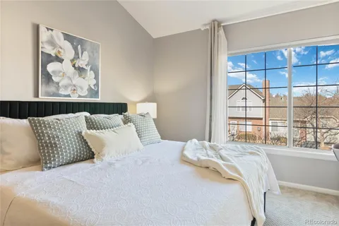 a bedroom with a large bed and a large window