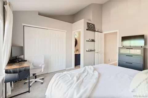 a bedroom with a bed and a chair