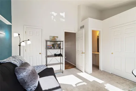 a living room with furniture and a walk in closet