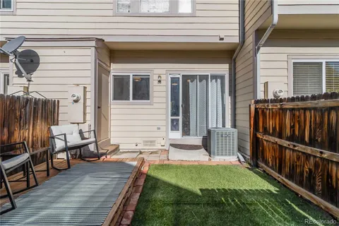 a view of backyard with deck and patio