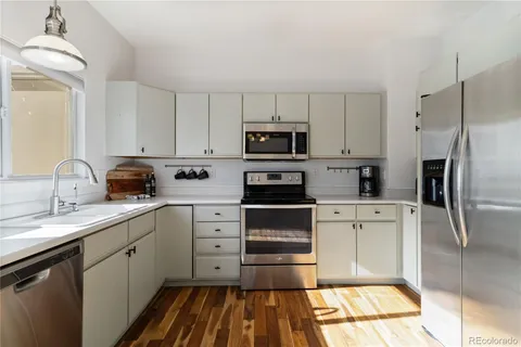a kitchen with a refrigerator stove and sink