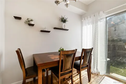 a view of a dining room with furniture and a chandelier fan
