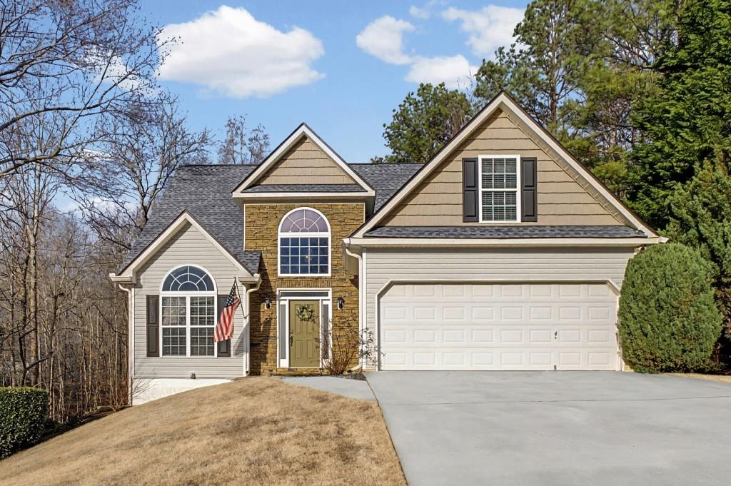 218 Amaranth Court Ball Ground, GA 30107 - Photo 1 of 39 a front view of a house with a yard and garage