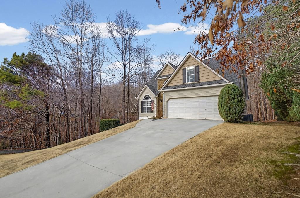 218 Amaranth Court Ball Ground, GA 30107 - Photo 37 of 39 a front view of a house with a yard and garage