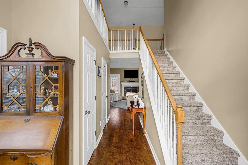 218 Amaranth Court Ball Ground, GA 30107 - Photo 4 of 39 a view of a hallway with wooden floor and staircase