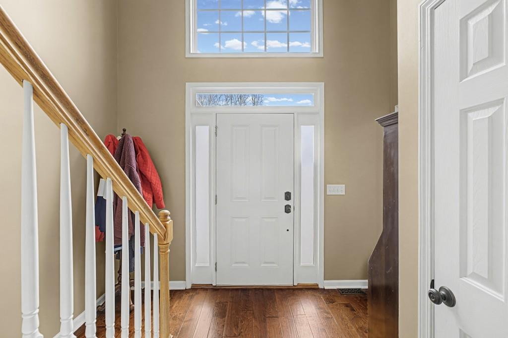 218 Amaranth Court Ball Ground, GA 30107 - Photo 5 of 39 a view of an entryway with wooden floor and staircase