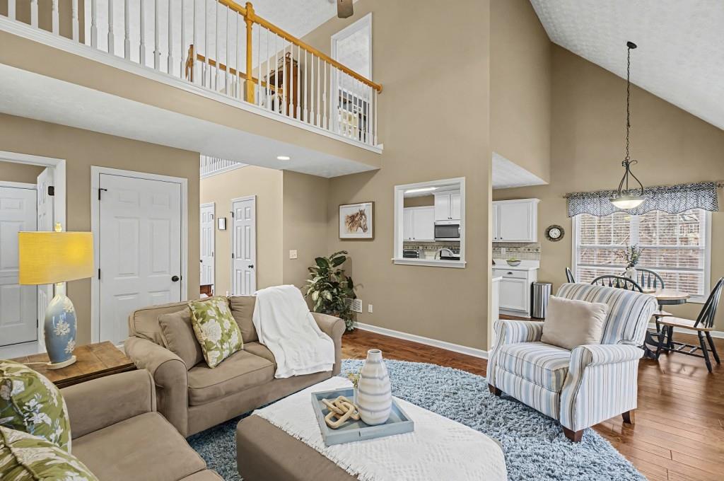 218 Amaranth Court Ball Ground, GA 30107 - Photo 10 of 39 a living room with furniture and a chandelier