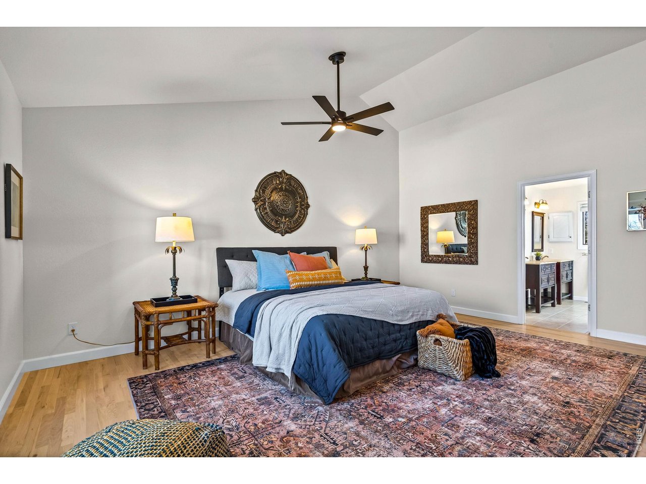 4133 Sumter Square Fort Collins, CO 80525 - Photo 26 of 42 a bedroom with a bed a chandelier and a window