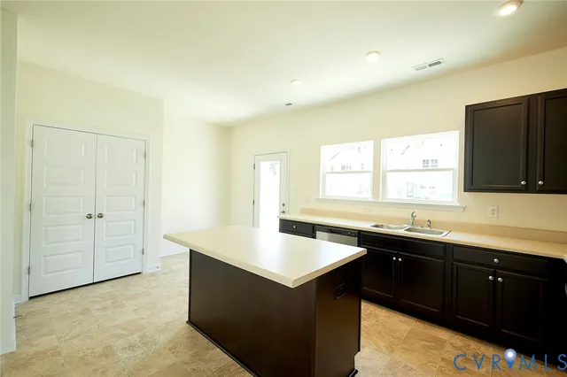 a kitchen with a sink and large window