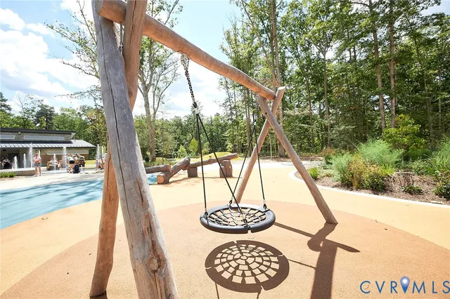 a view of swimming pool with a patio and palm trees
