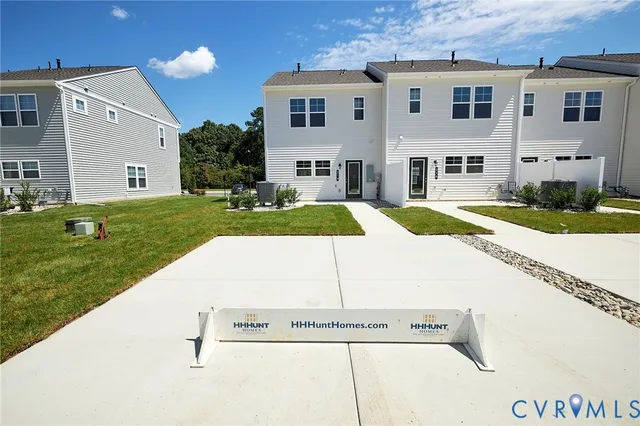 a view of a white house with a yard