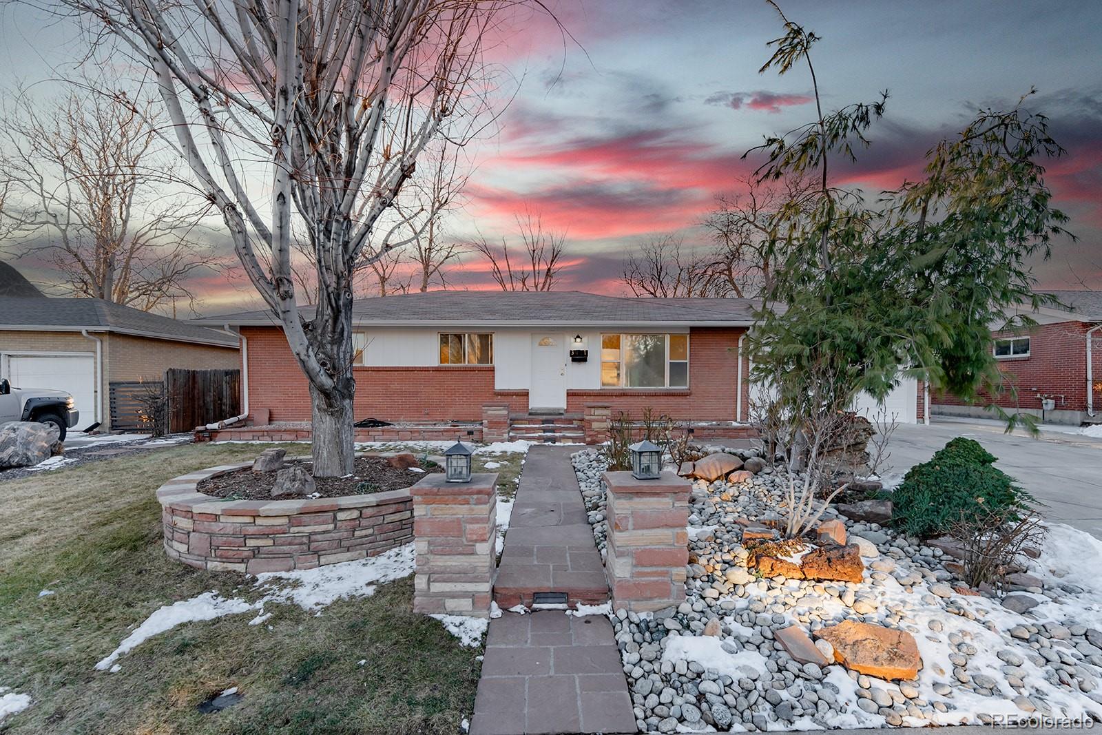 3091 South Yates Street Denver, CO 80236 - Photo 1 of 46 a front view of house with yard and seating space