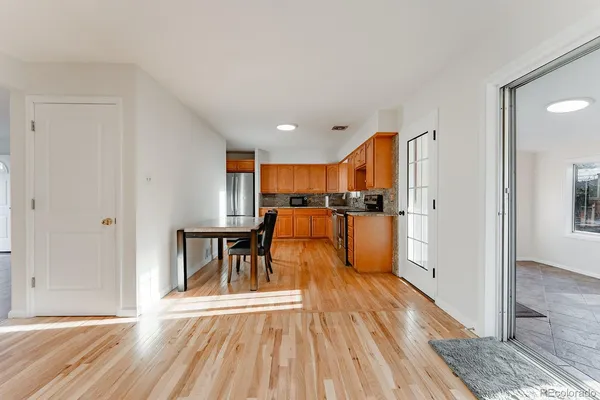 a view of kitchen with furniture and wooden floor