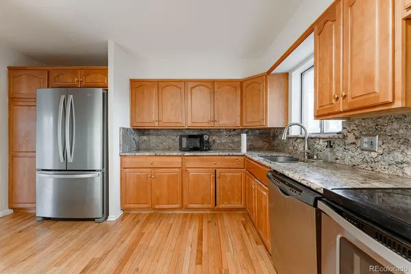 a kitchen with stainless steel appliances granite countertop a refrigerator sink and cabinets