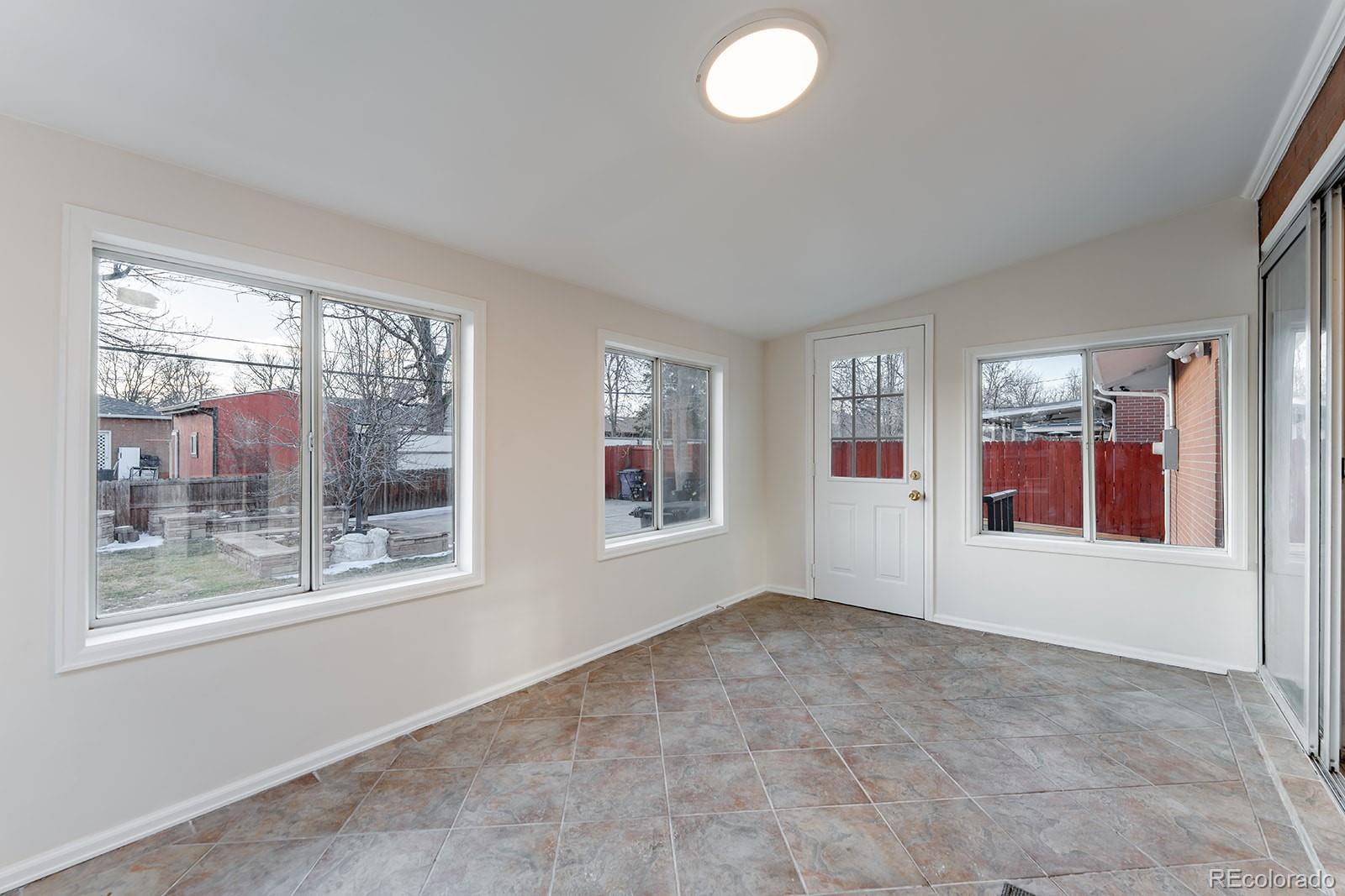 3091 South Yates Street Denver, CO 80236 - Photo 18 of 46 an empty room with windows