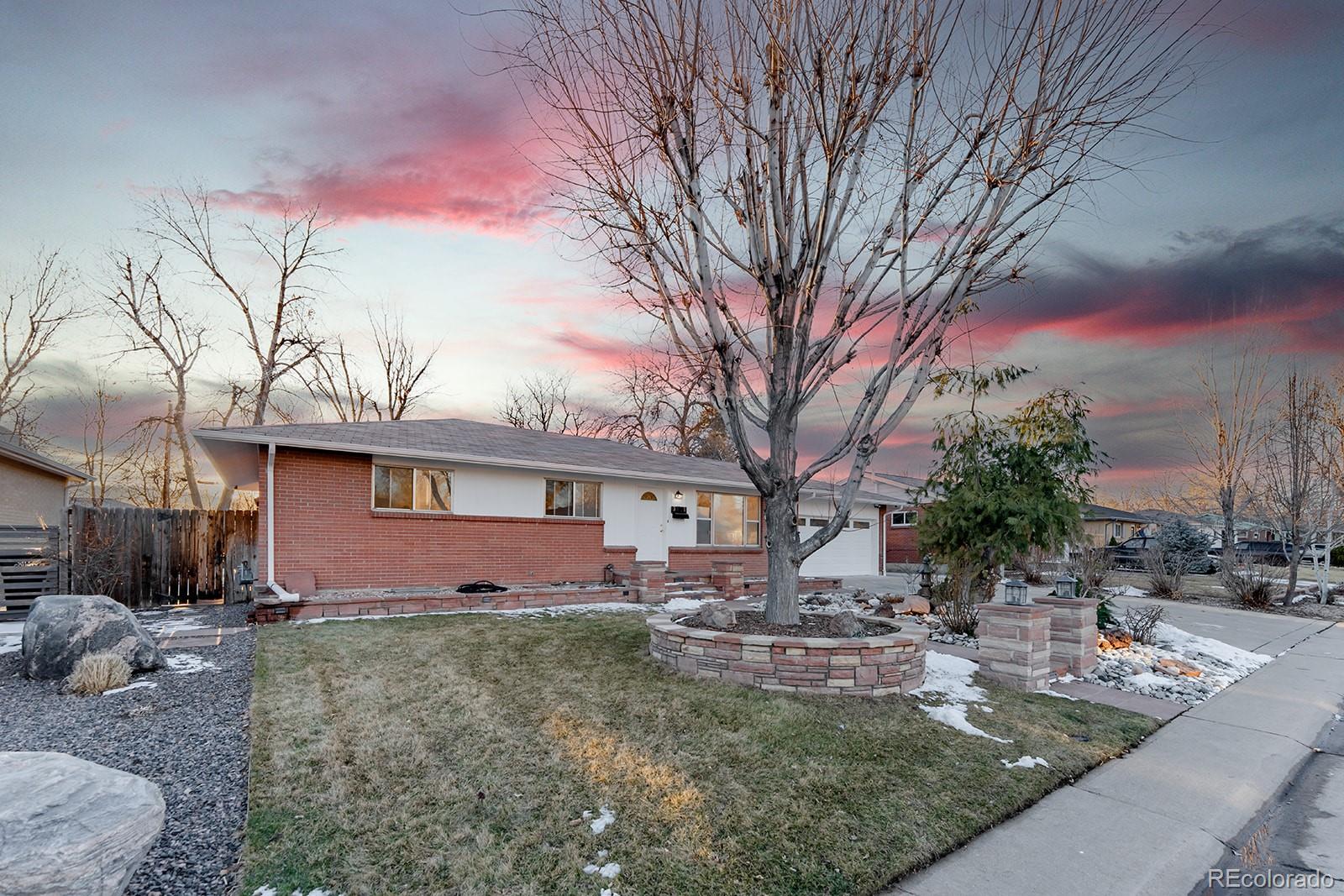 3091 South Yates Street Denver, CO 80236 - Photo 2 of 46 a front view of a house with garden
